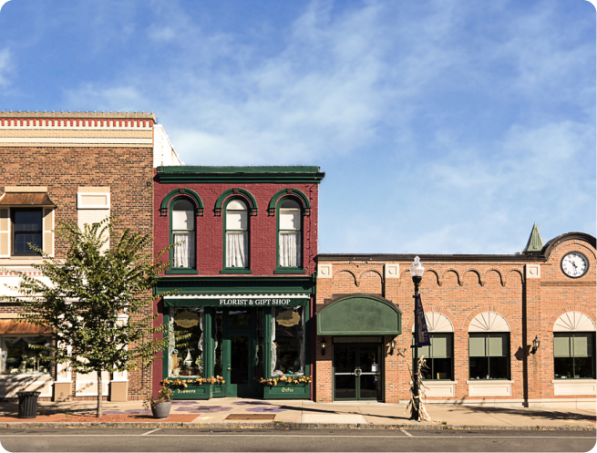 A small town mainstreet with three stores side by side.