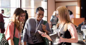 A group of government employees is looking at content taken from an attendee's phone.